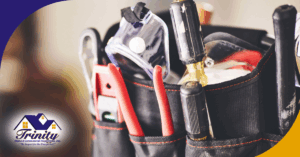 Close-up of a tool belt filled with various home inspection tools.