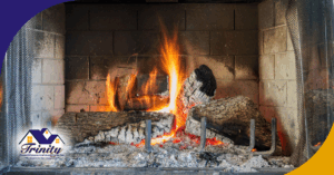 A roaring fire burns brightly in a stone fireplace, with logs cracked and smoldering.