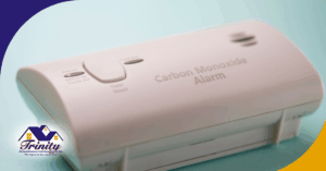 A close-up of a carbon monoxide alarm with a blue background.