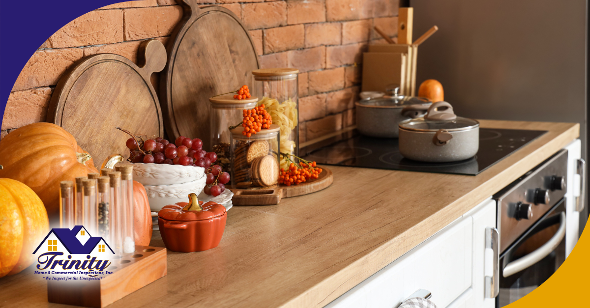 Cozy kitchen counter decorated with pumpkins, grapes, spice jars, and autumn-themed accents.