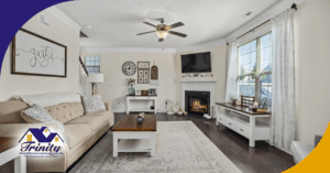 A cozy living room with a fireplace, couch, and TV mounted on the wall.
