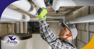 A person inspecting plumbing pipes in a basement.